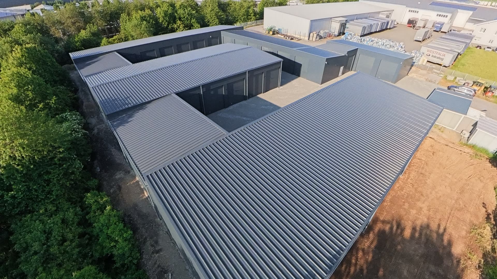 Luftaufnahme — der Garagenpark eingebettet zwischen Gewerbegebiet, Bäumen und Feldern des Maifelds